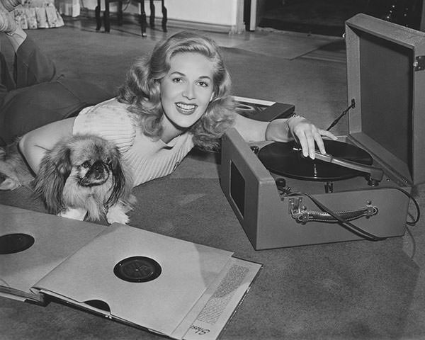 Woman listening to record player